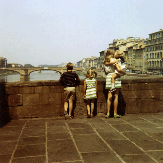 Vintage photo with mom and son standing on bridge looking over river